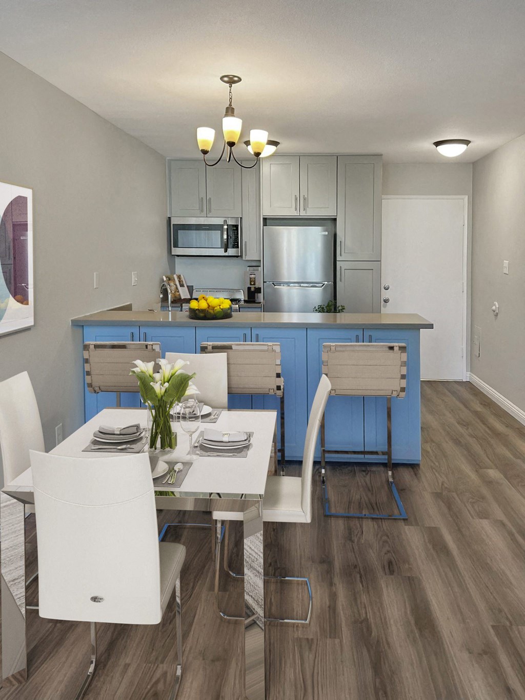 a kitchen and dining room with blue cabinets and a table and chairs