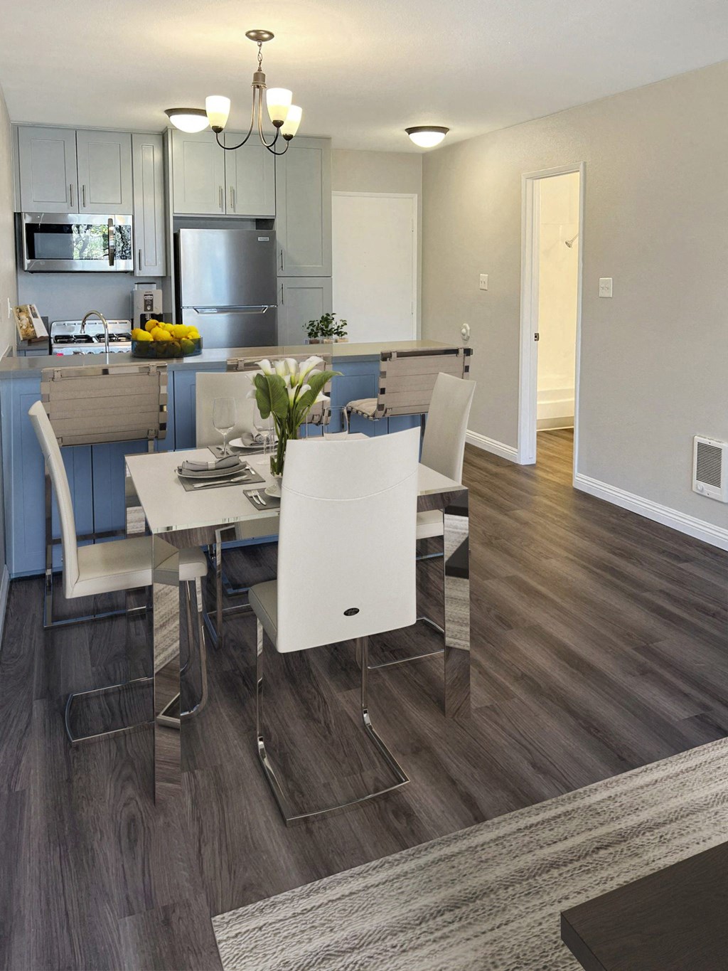 a kitchen and dining room with a table and chairs