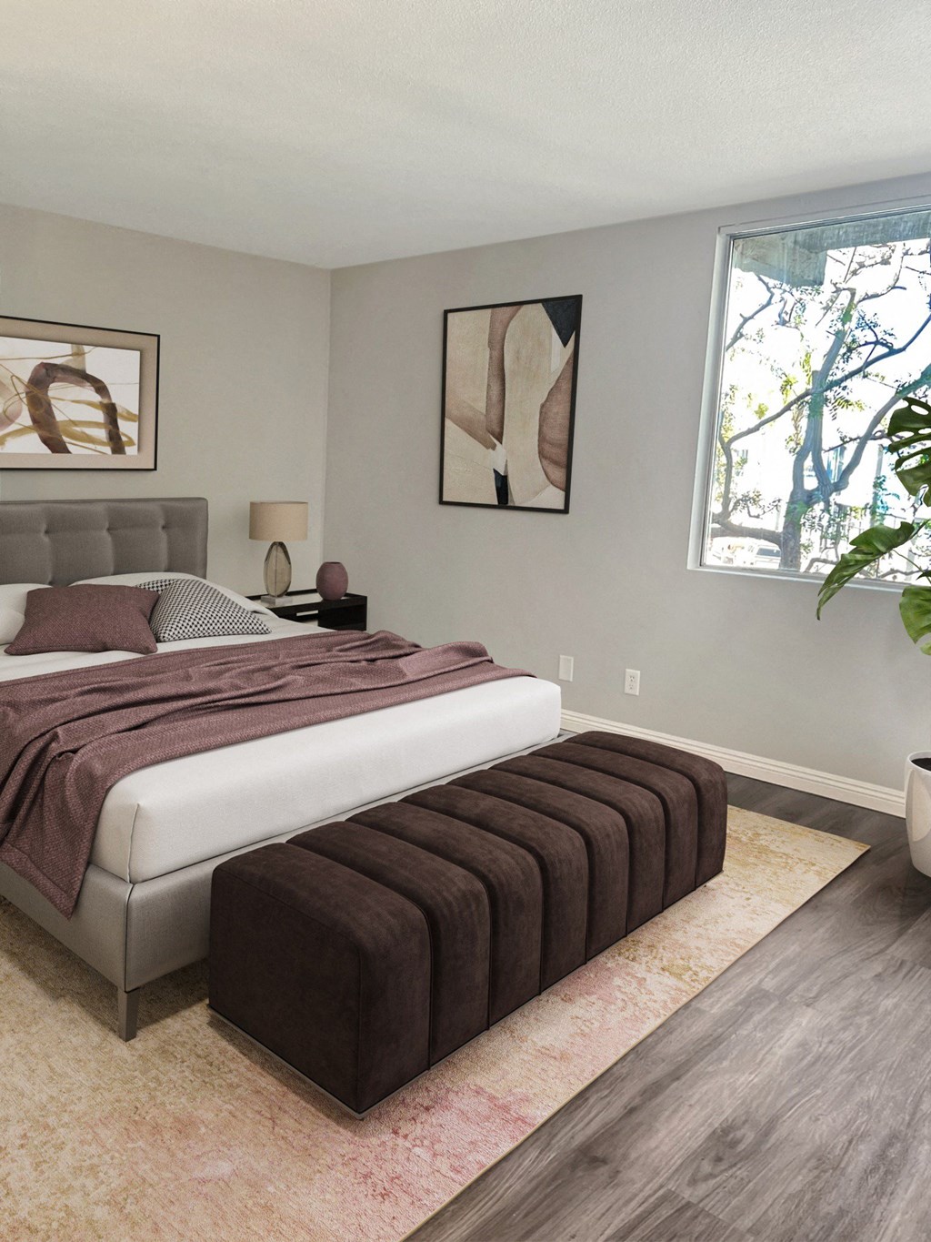 a bedroom with a white bed and a brown blanket