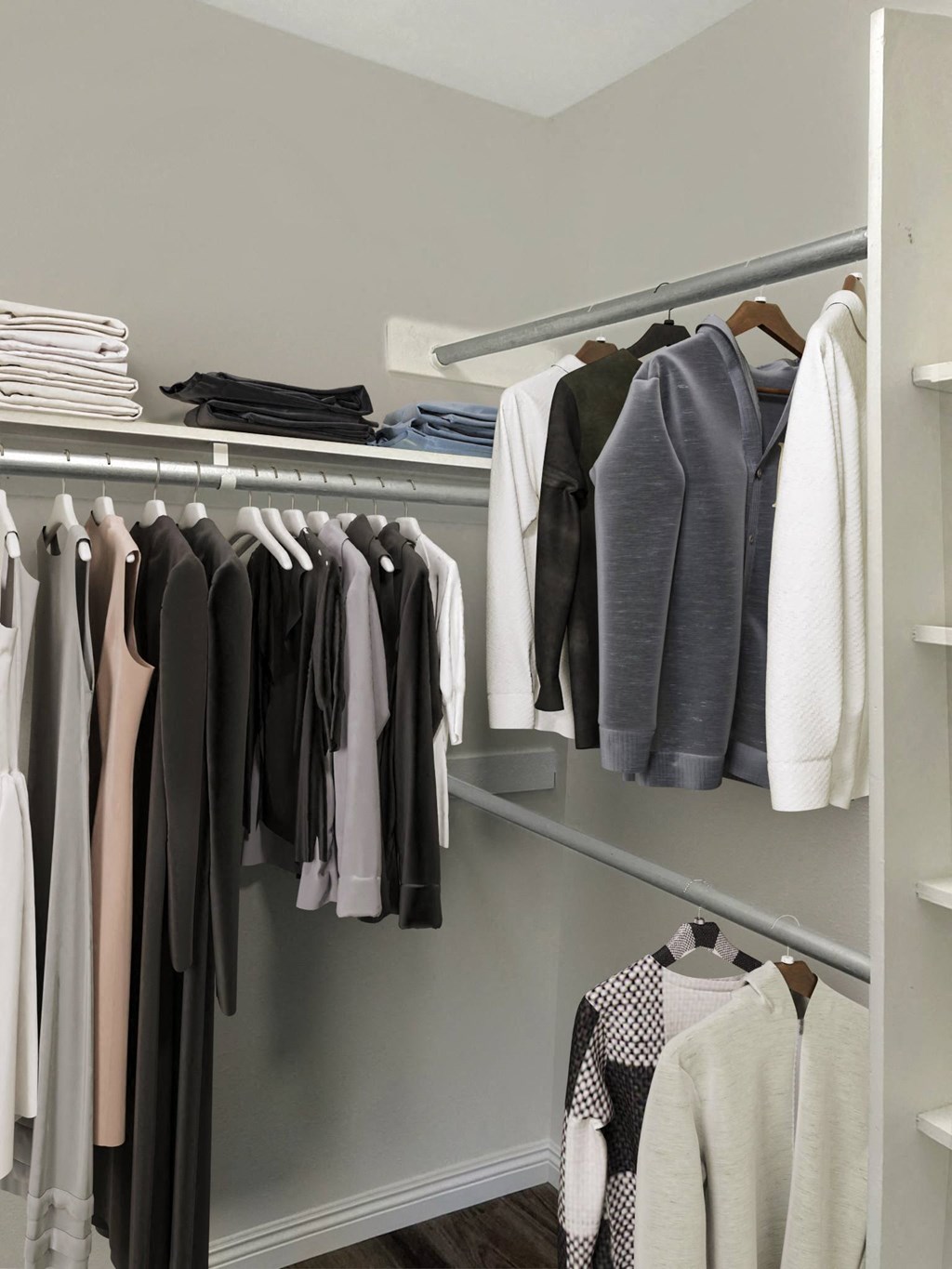 a walk in closet with a rack of clothes hanging on it