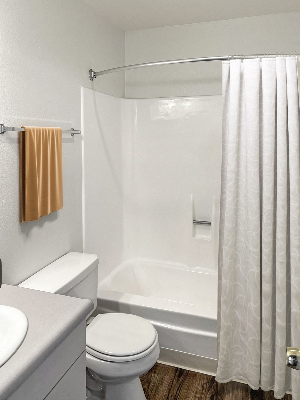 a bathroom with a shower and a toilet and a sink