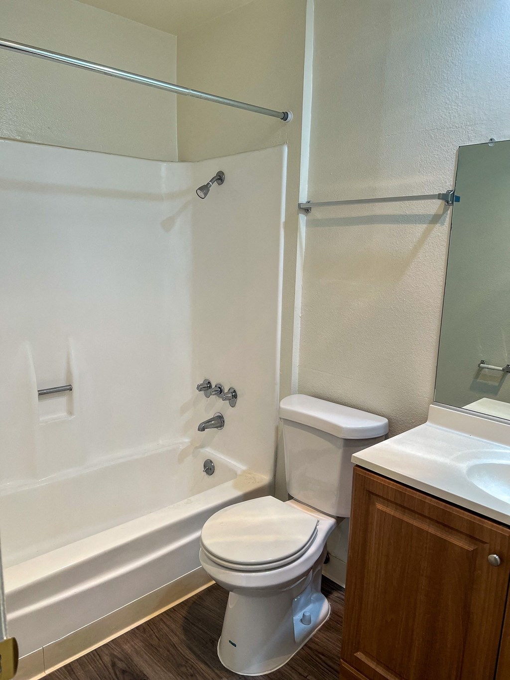 a bathroom with a toilet and a shower and a sink