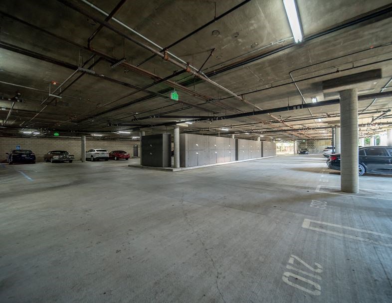 an empty parking garage with cars parked in it