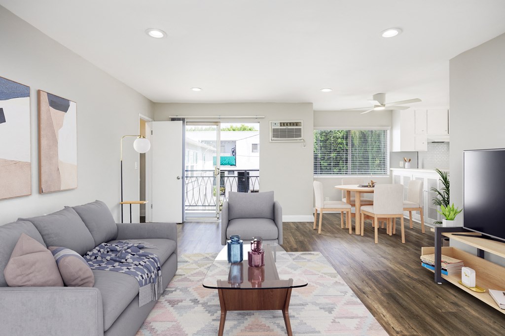 a living room and dining room with couches and a table