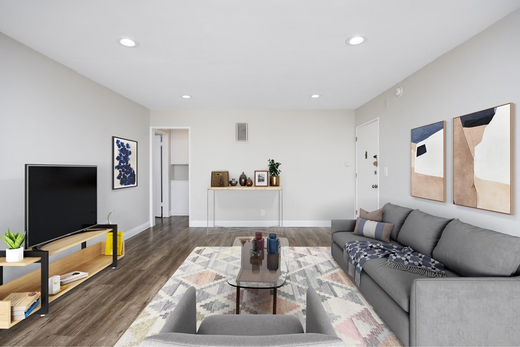 a living room with a gray couch and a tv