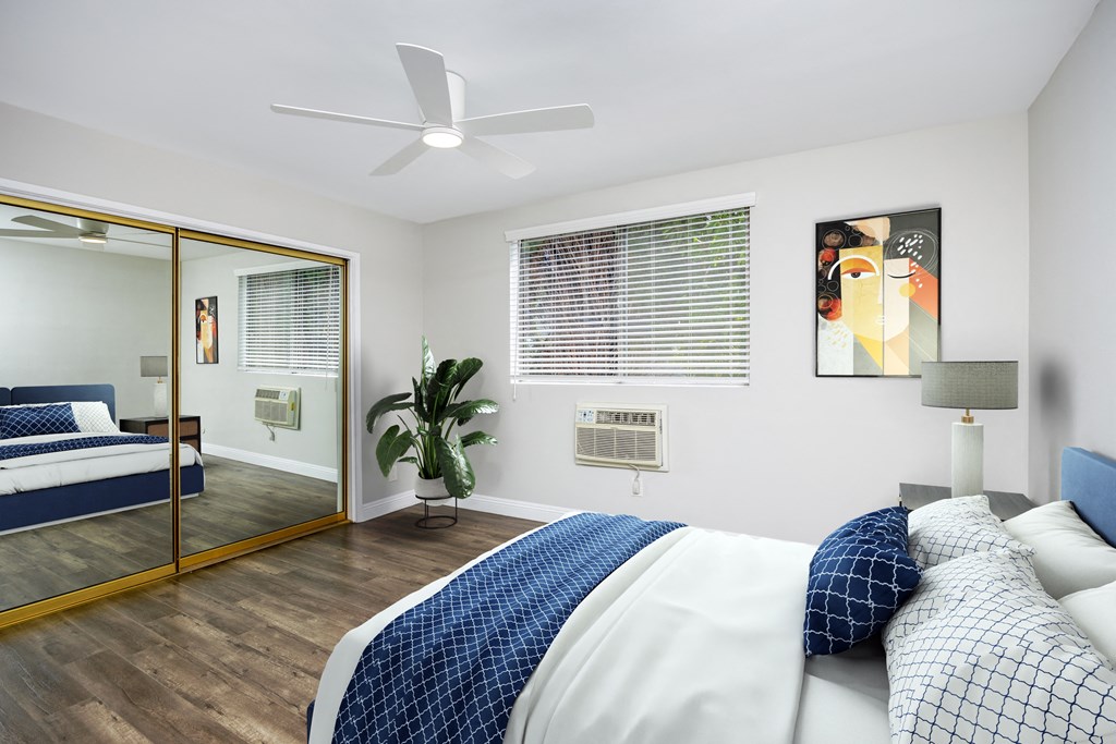 a bedroom with a large bed and a mirror