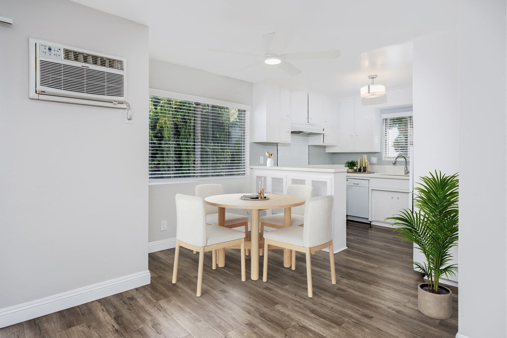 a dining room with a table and chairs and a kitchen