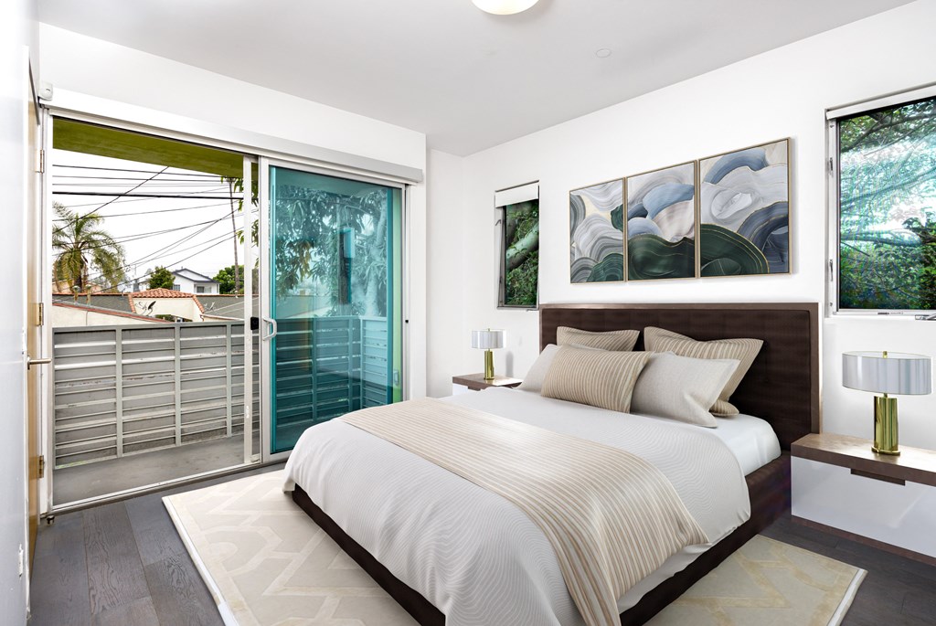 a bedroom with a bed and a sliding glass door
