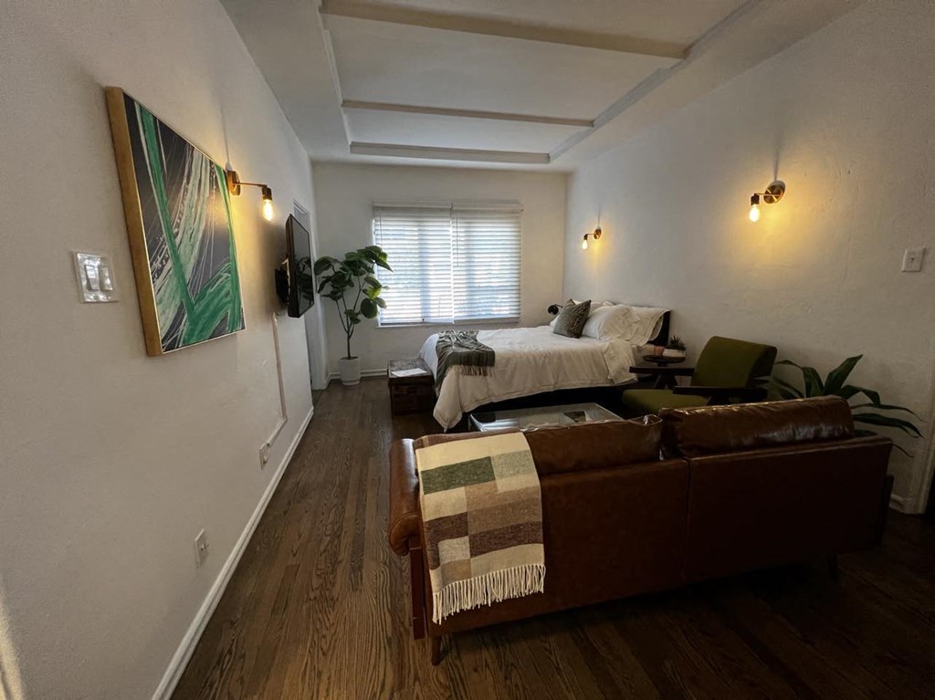 a living room with a couch and a bed