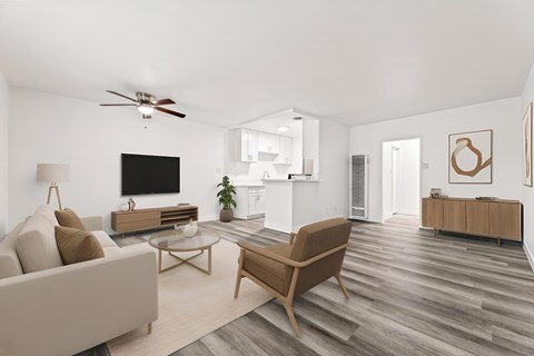 A living room with a brown chair, a white couch, and a wooden coffee table.