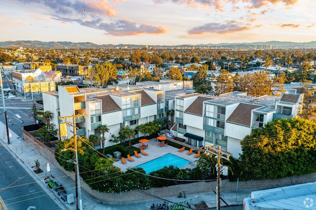 a building with a pool and a city in the background