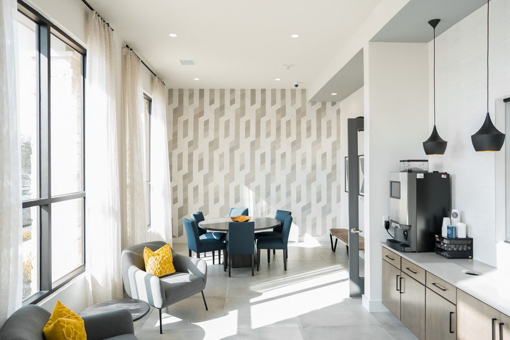 Apartments for Rent in College Station - Community Coffee Bar with Large Windows, Plush Seating Area and Table with Six Chairs.