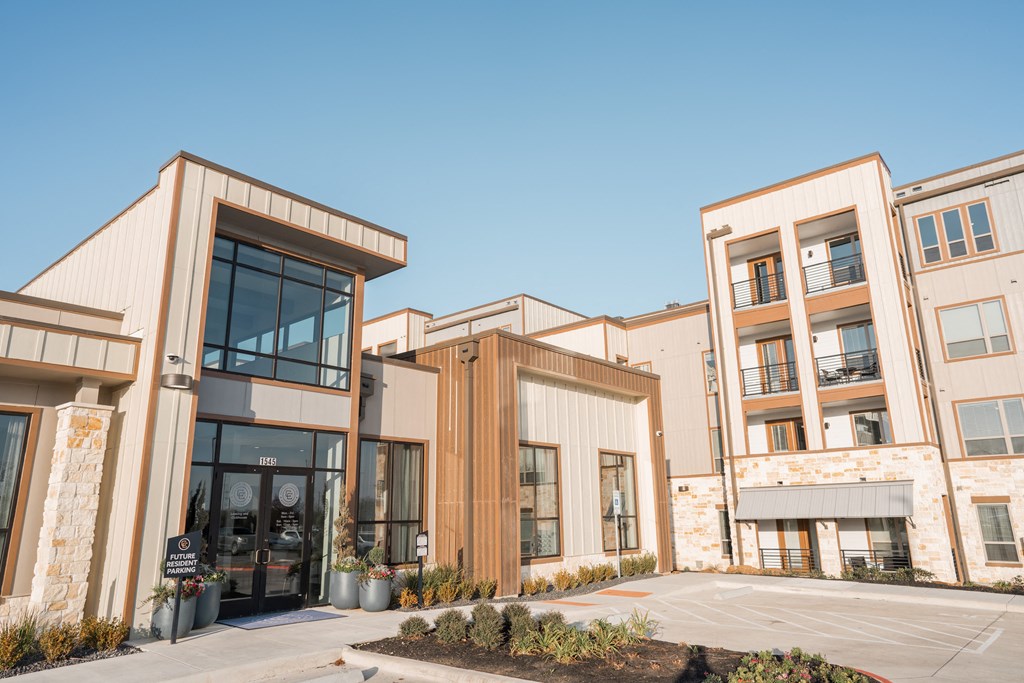 a group of apartment buildings with a parking lot