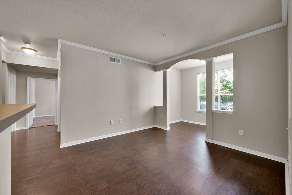 a living room with hardwood floors and grey walls