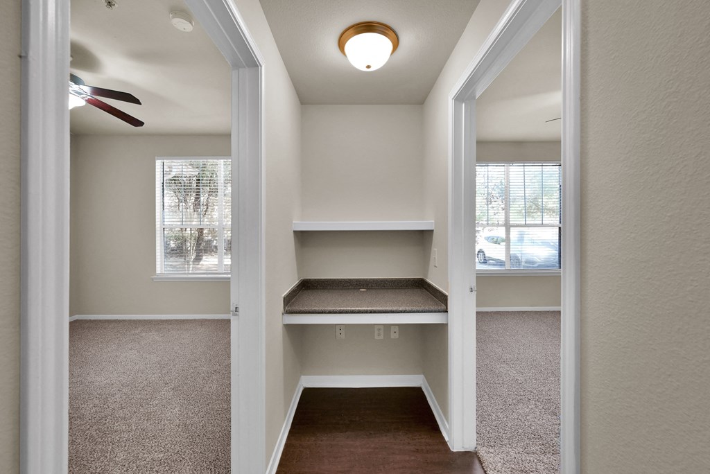an empty walk in closet with a ceiling fan