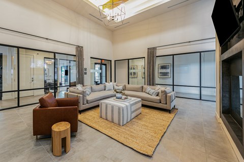 A modern living room with a large sectional sofa and a coffee table.