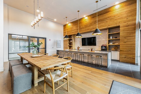 A modern kitchen with a wooden table and chairs.