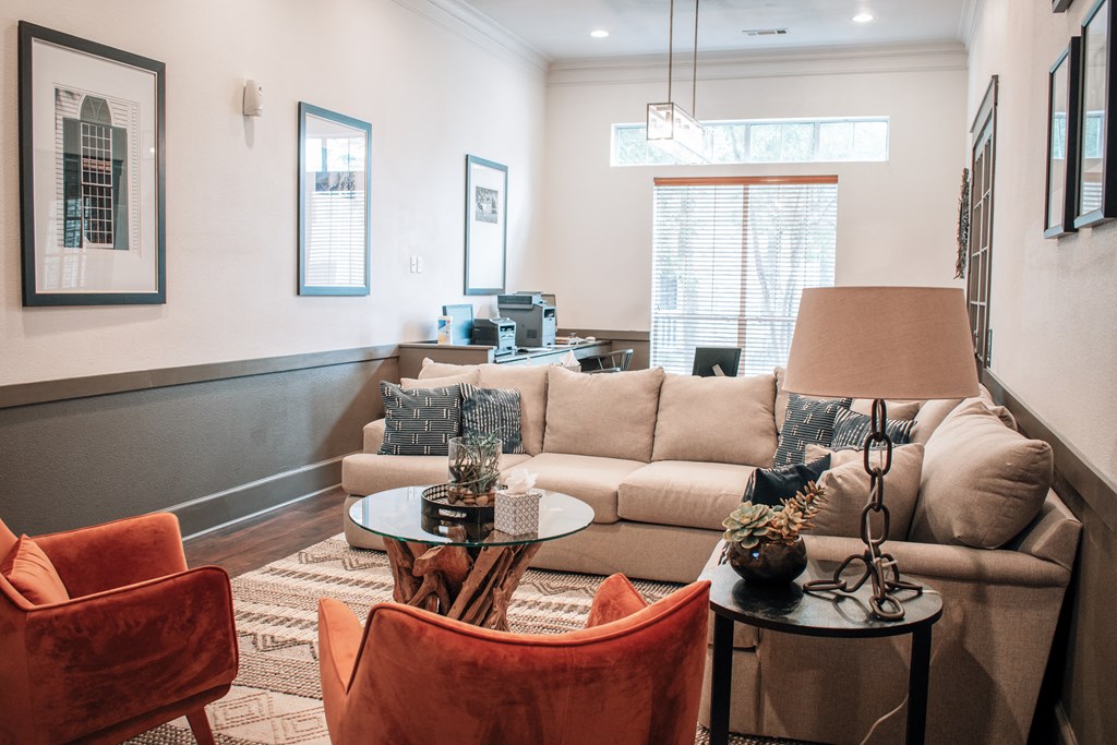 a living room with a couch and chairs