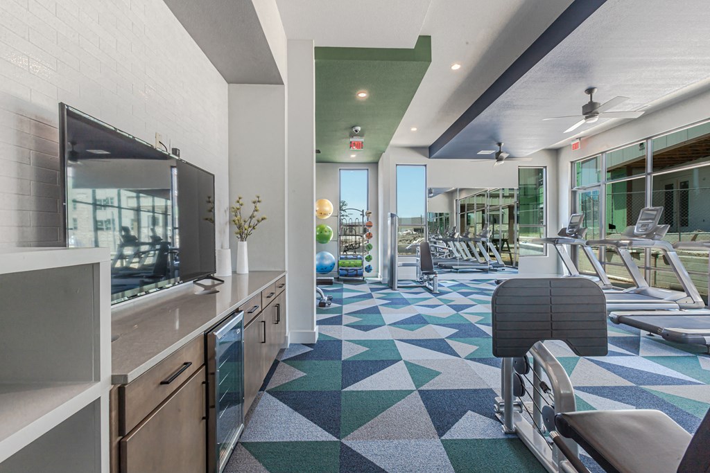 College Station, TX Apartments for Rent - Caprock Crossing Fitness Center with treadmills, ellipticals, free weights, and more