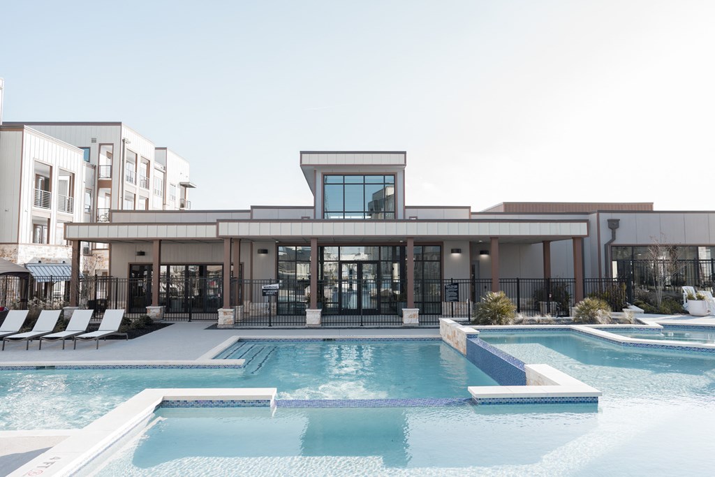 a building with a swimming pool in front of it