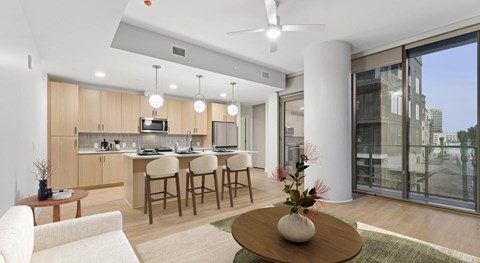 A modern kitchen with a dining table and chairs.