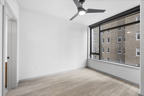 Bedroom with large windows and ceiling fan 1909 Rittenhouse