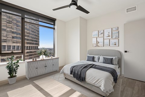 Interior Image of Bedroom with Large WIndows and Ceiling Fan