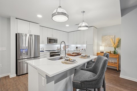 A modern kitchen with a dining table and chairs.