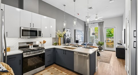 A modern kitchen with a stove top oven and microwave above it.