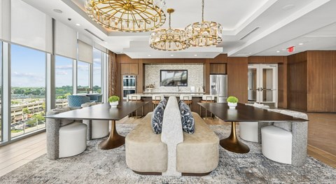 A modern living room with a large sectional sofa and a chandelier.