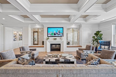 A living room with a fireplace and a television on the wall.