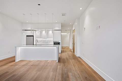 A long hallway with a white counter on the left side.
