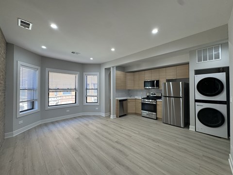 A spacious kitchen with a washer and dryer built into the cabinetry.