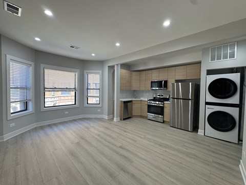 A spacious kitchen with a washer and dryer built in.