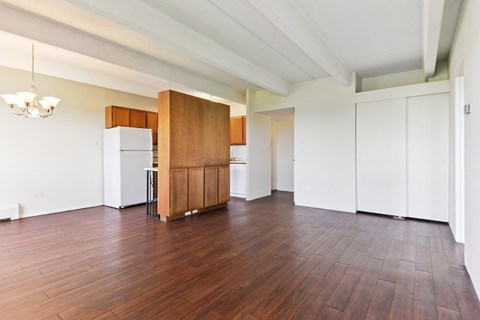 A kitchen with white cabinets and a wooden island.