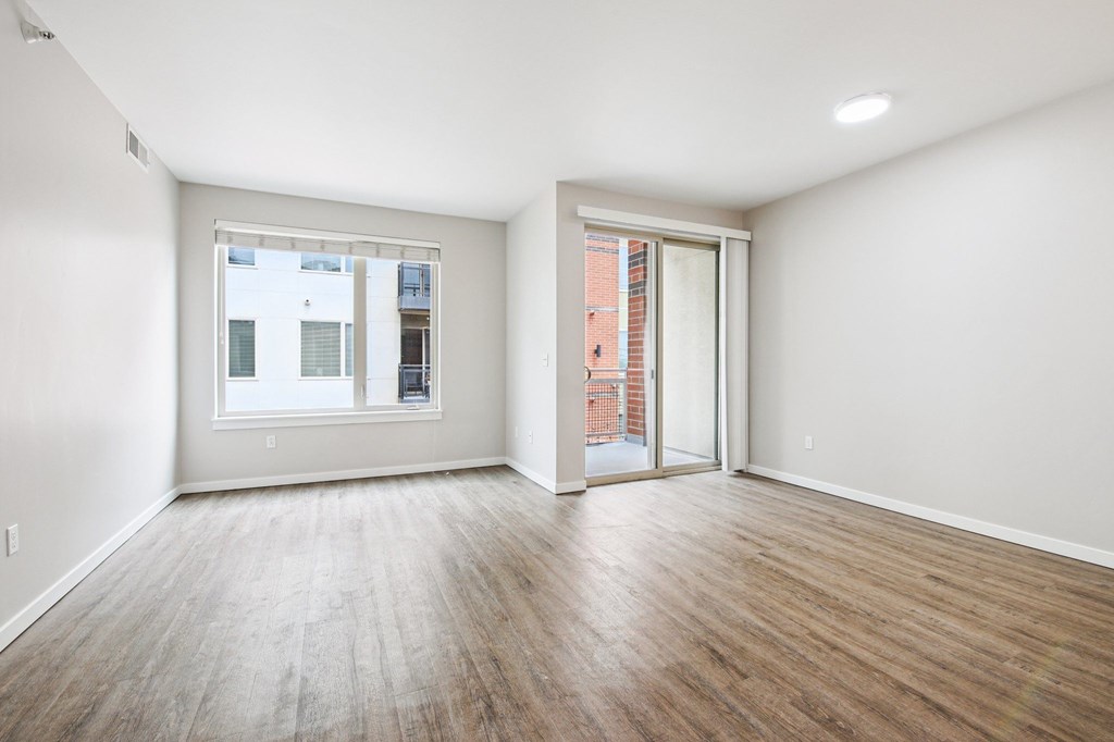 A room with a window and sliding glass door.