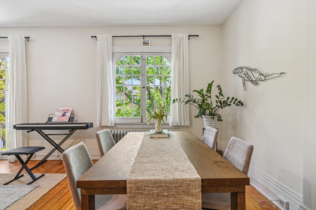a dining room with a table and chairs and a window
