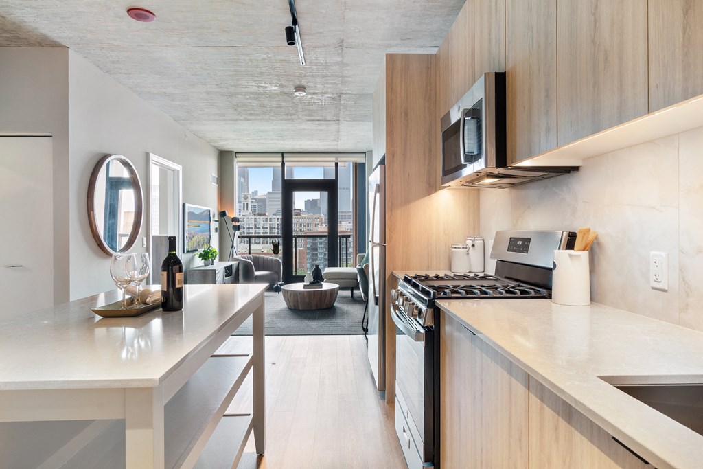 a kitchen with a counter top and a stove and a microwave