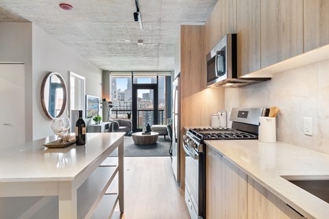 a kitchen with a counter top and a stove and a microwave