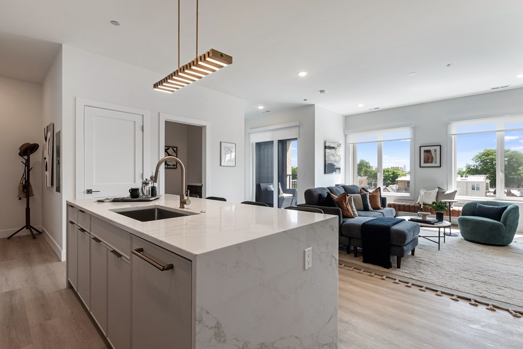 A modern kitchen with a marble countertop and a large island.