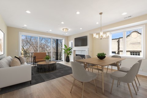 A modern dining room with a wooden table and chairs.