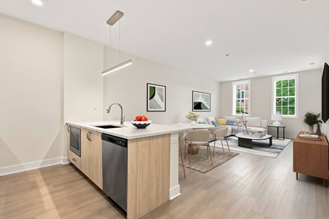 A modern kitchen with a wooden island and stainless steel appliances.