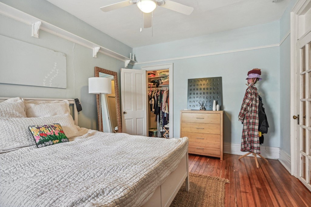 a bedroom with a bed and a closet with a dresser