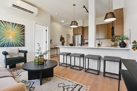 A living room with a black table and a green chair.