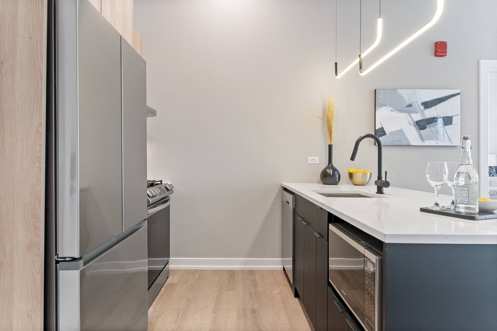 a kitchen with stainless steel appliances and a white counter top