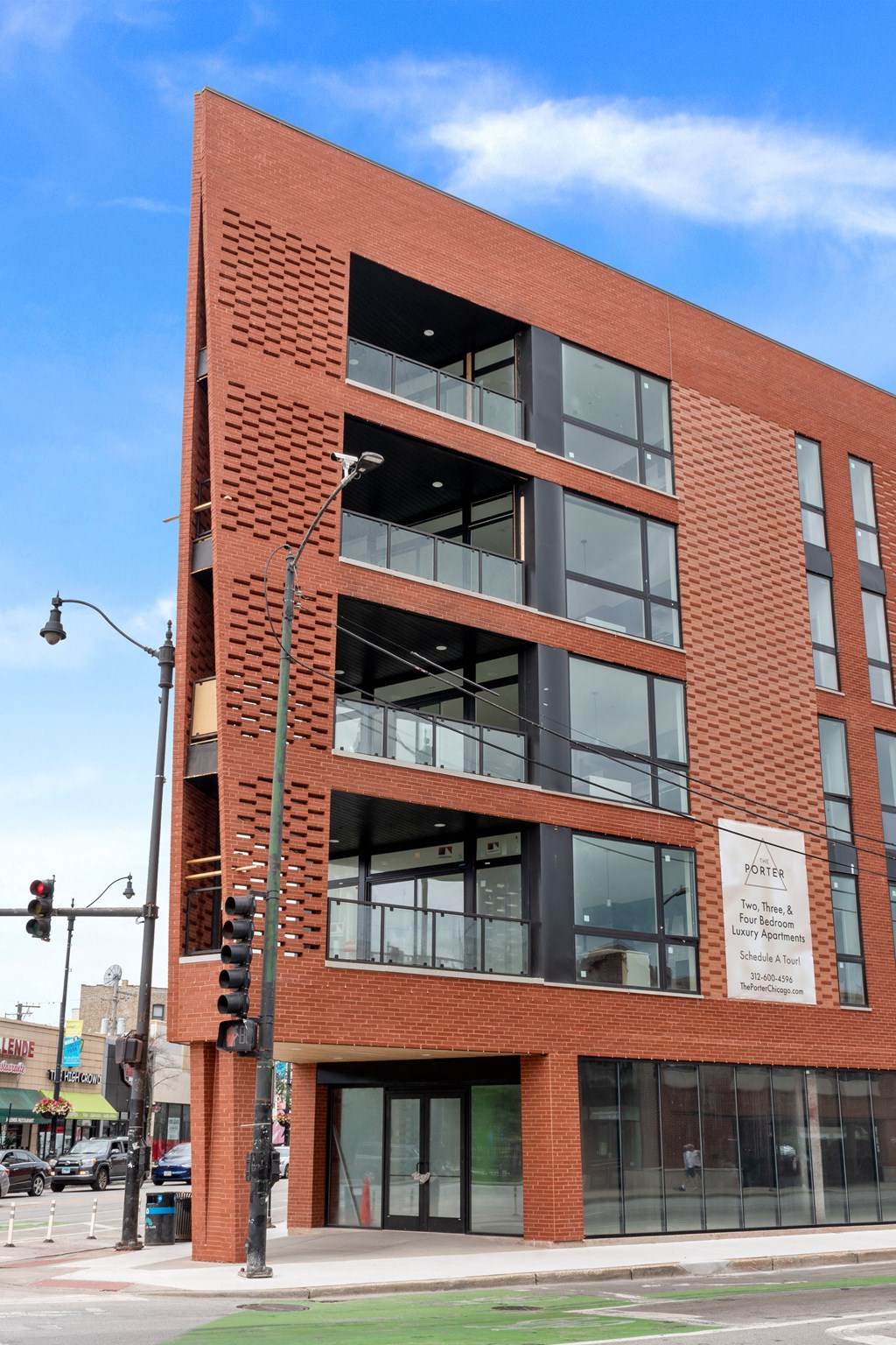 a red brick building with many windows and a street light in front of it