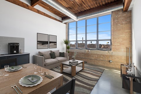 a living room with a couch and a table and a large window