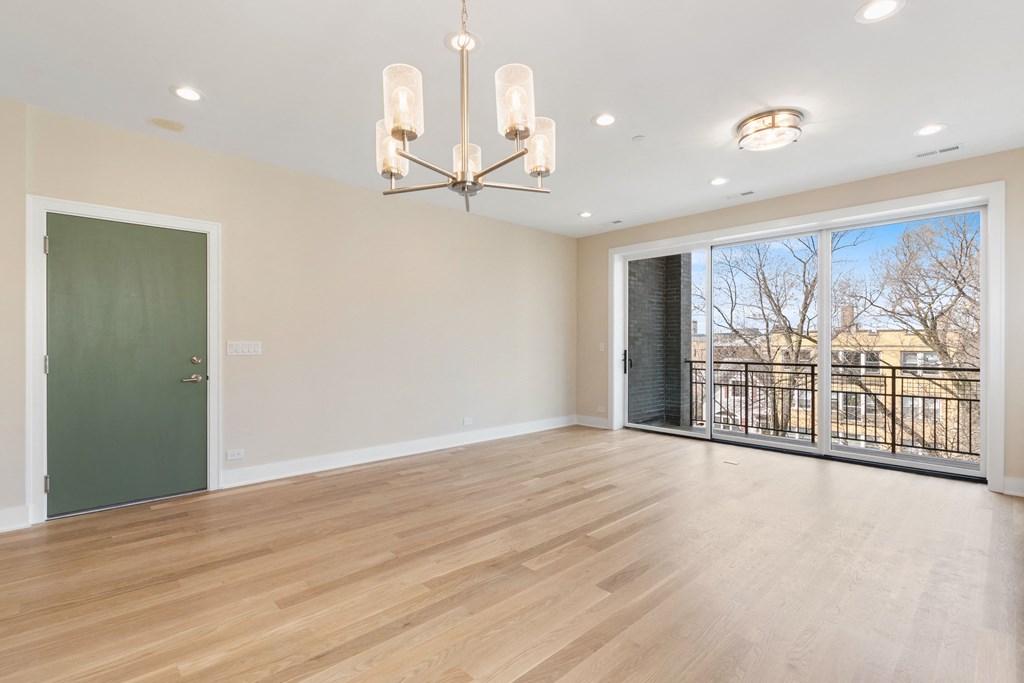 a living room with a large window and a green door