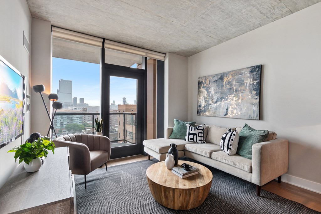 a living room with a couch and a table and a large window