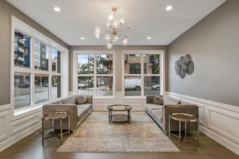 a living room with couches and chairs and a chandelier